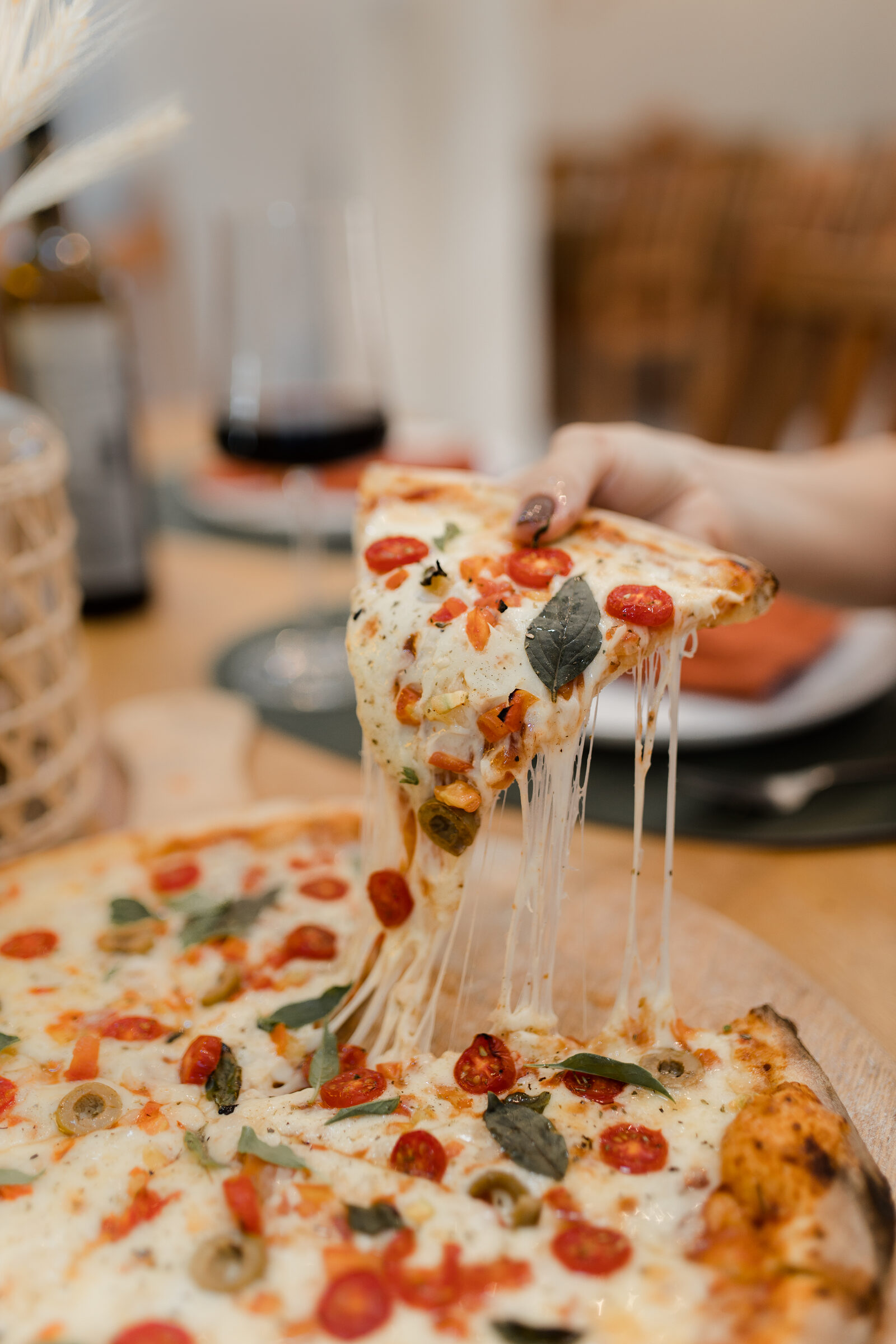 Fatia de pizza da Cia Casero, com o queijo puxando